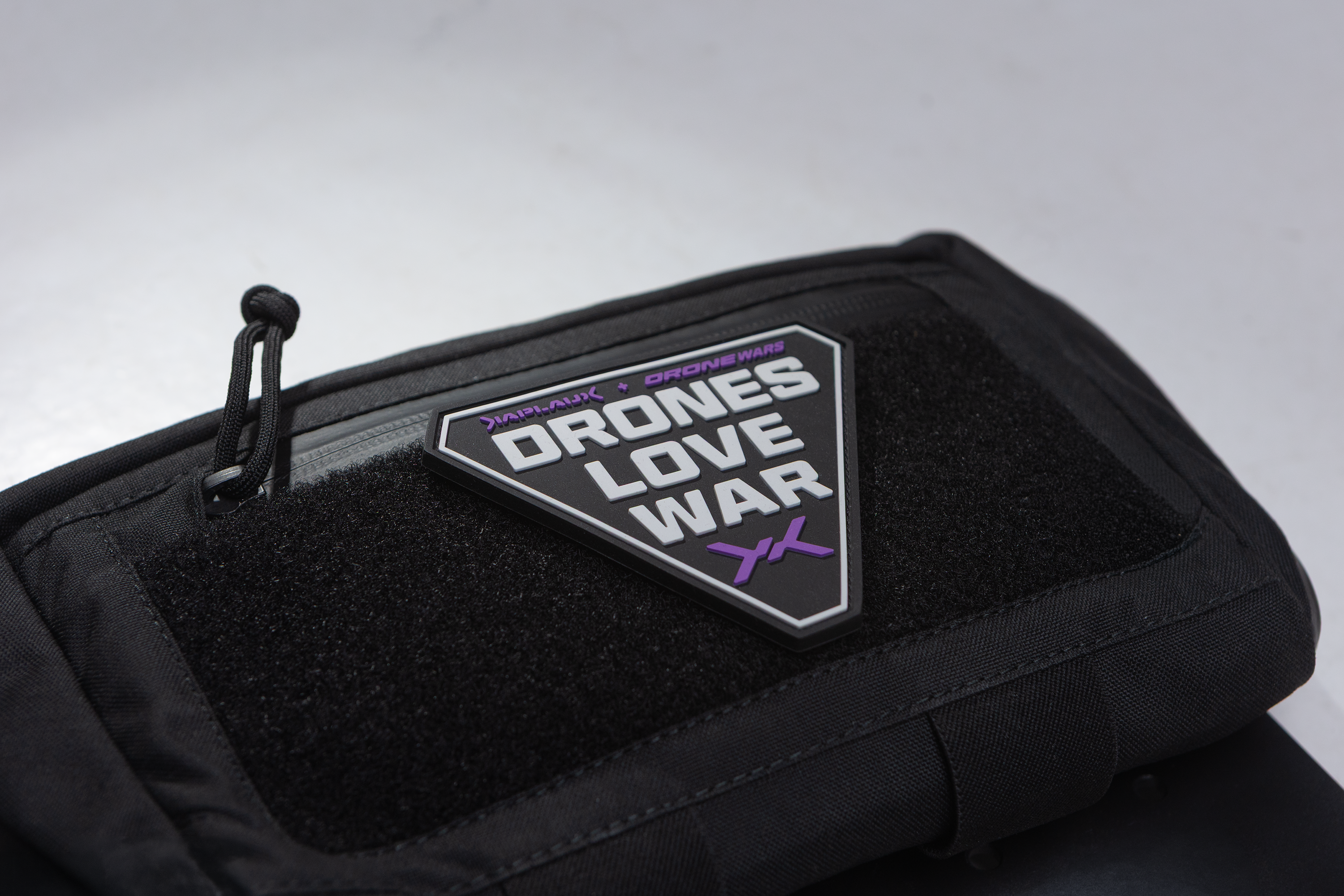 Black pouch with 'Drones Love War' patch sick to velcro
